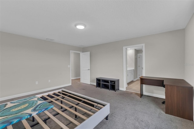 unfurnished bedroom featuring ensuite bath, visible vents, baseboards, and carpet