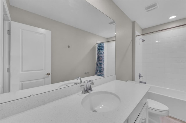 bathroom featuring vanity, shower / bath combo with shower curtain, toilet, and visible vents