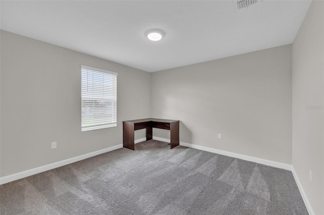 empty room with visible vents, baseboards, and carpet floors