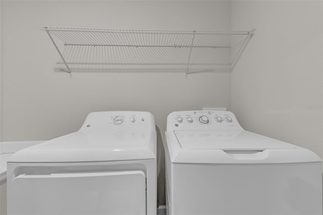 washroom featuring washing machine and dryer and laundry area