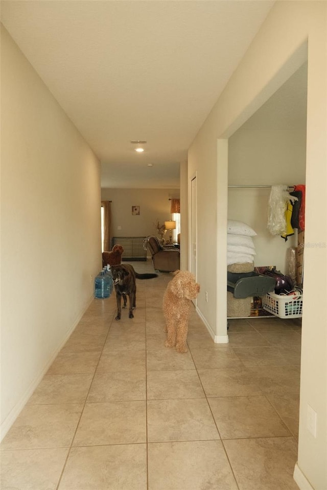 hall with tile patterned flooring and baseboards