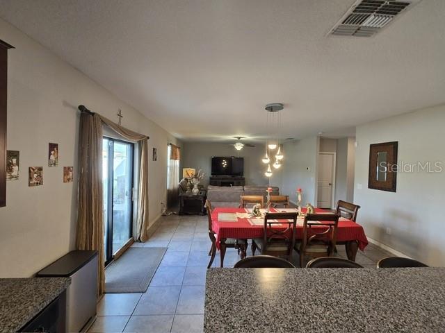 dining space with light tile patterned floors and visible vents