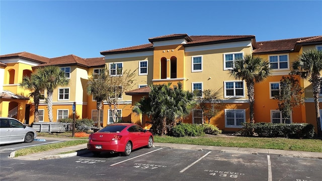 view of property with uncovered parking and a residential view