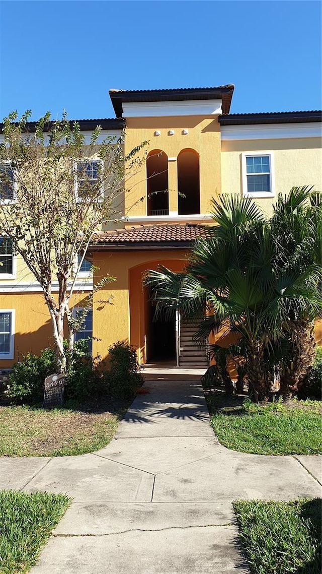 view of front of home with a tile roof and stucco siding