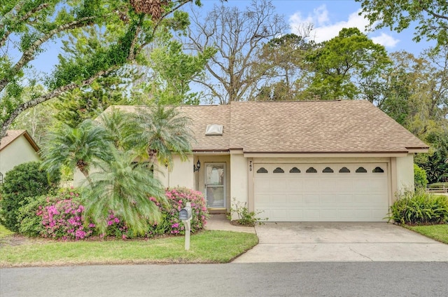 view of front of house featuring a shingled roof, a garage, driveway, and stucco siding