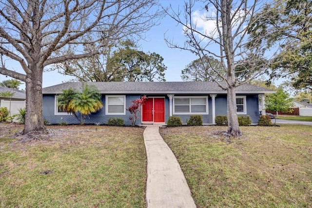 ranch-style house with brick siding and a front lawn