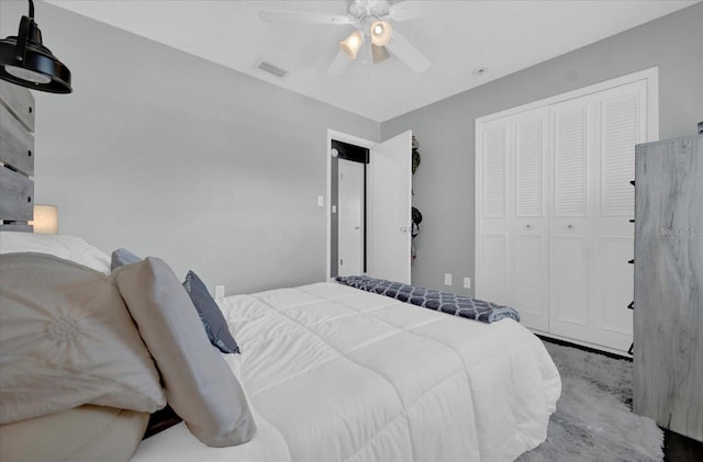 bedroom with a closet, visible vents, and ceiling fan