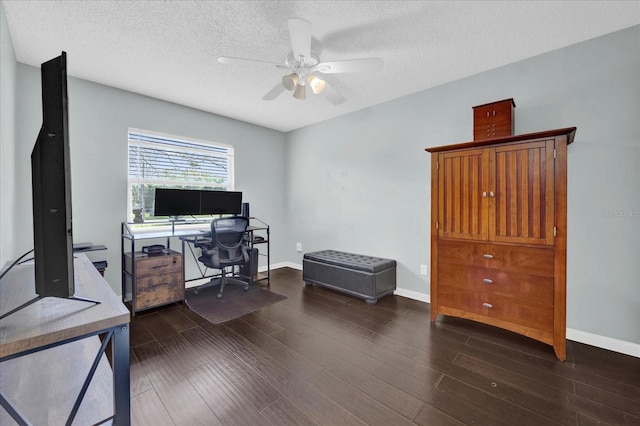 home office featuring a textured ceiling, ceiling fan, wood finished floors, and baseboards