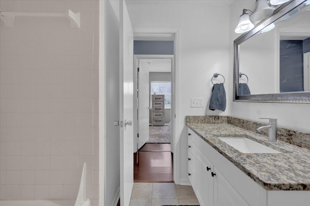 full bath featuring a shower, tile patterned flooring, vanity, and baseboards