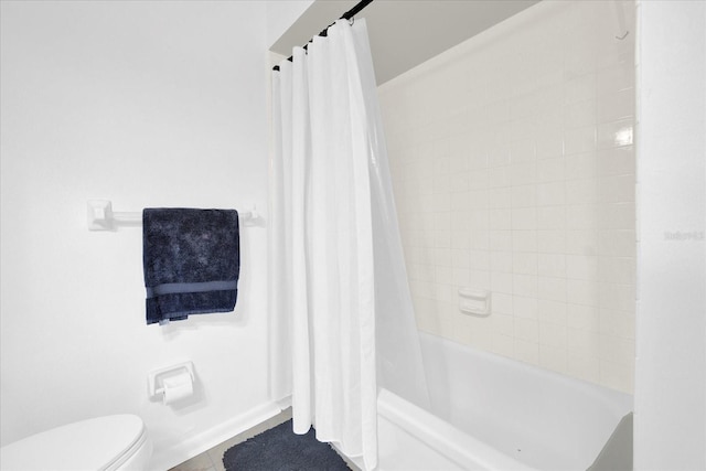 full bath featuring toilet, tile patterned flooring, and shower / tub combo with curtain