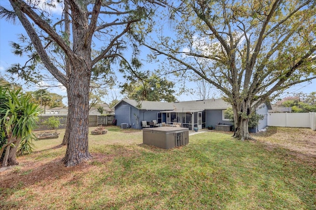 view of yard with a sunroom and a fenced backyard