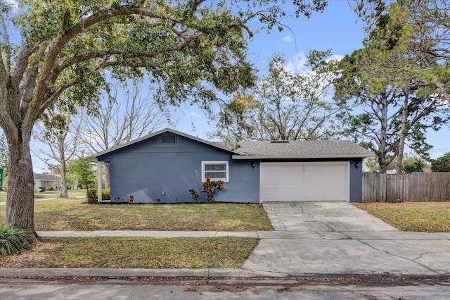 view of front of house with a garage, a front yard, driveway, and fence