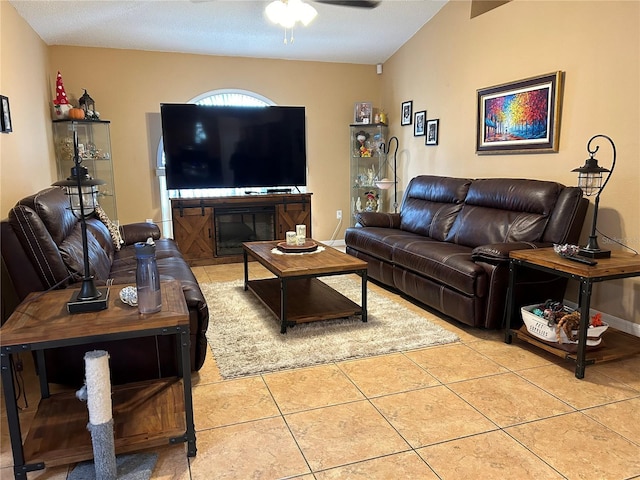 living area with light tile patterned floors, ceiling fan, and baseboards