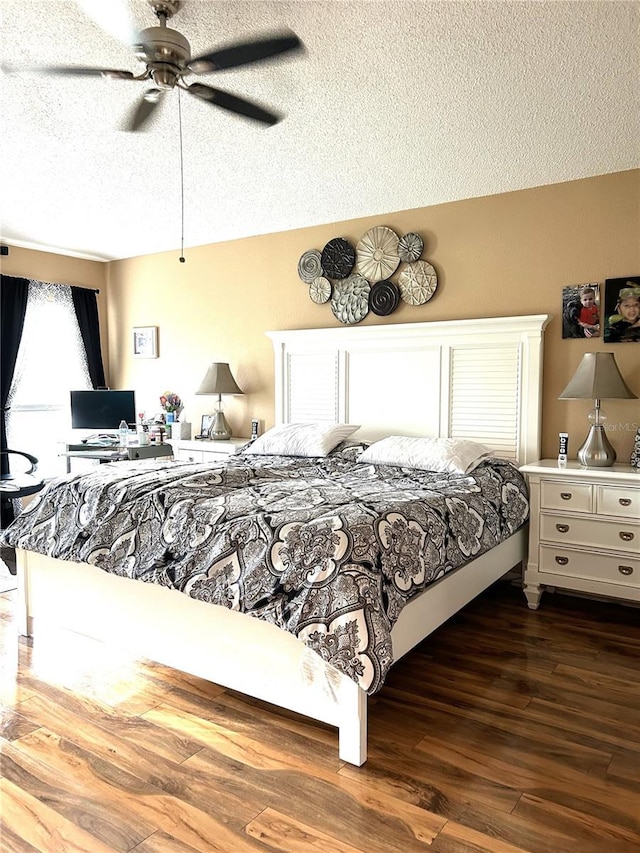 bedroom featuring dark wood-style floors, a textured ceiling, and a ceiling fan