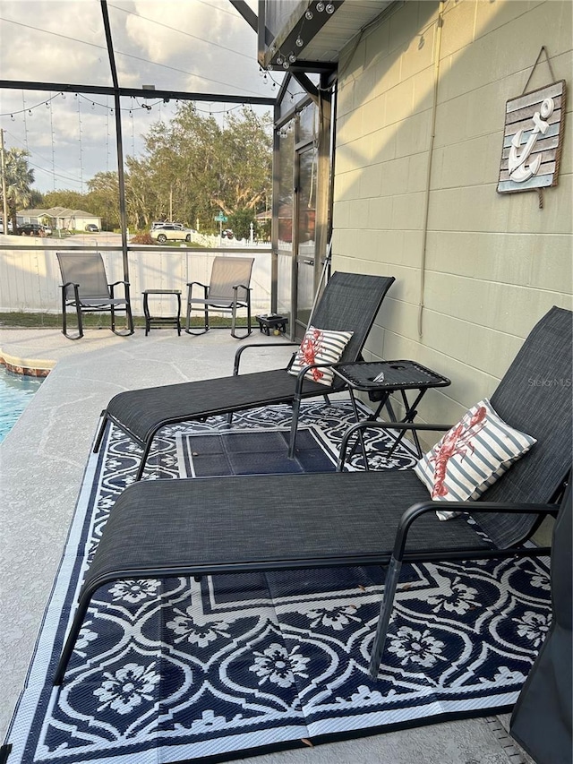 view of patio featuring glass enclosure and a fenced in pool