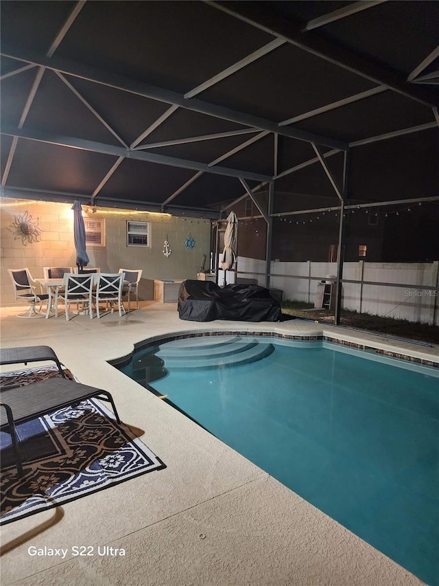 view of pool featuring a lanai, a patio area, fence, and a fenced in pool