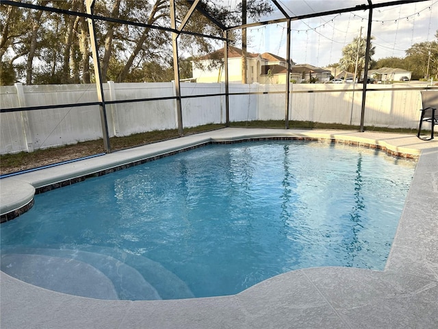 view of pool with a lanai, a fenced backyard, and a fenced in pool