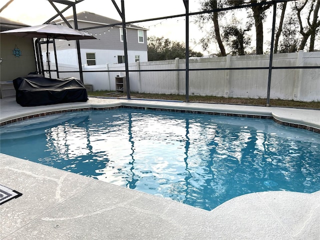 view of swimming pool with a fenced backyard, a patio area, a lanai, and a fenced in pool