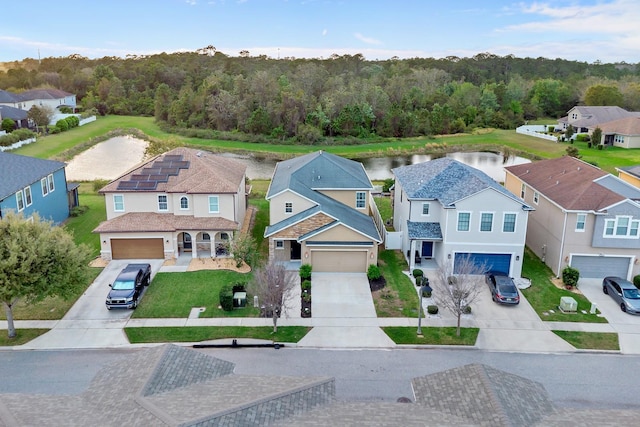 bird's eye view featuring a water view, a residential view, and a view of trees