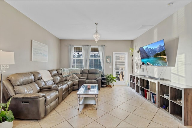 living area featuring a notable chandelier and light tile patterned flooring