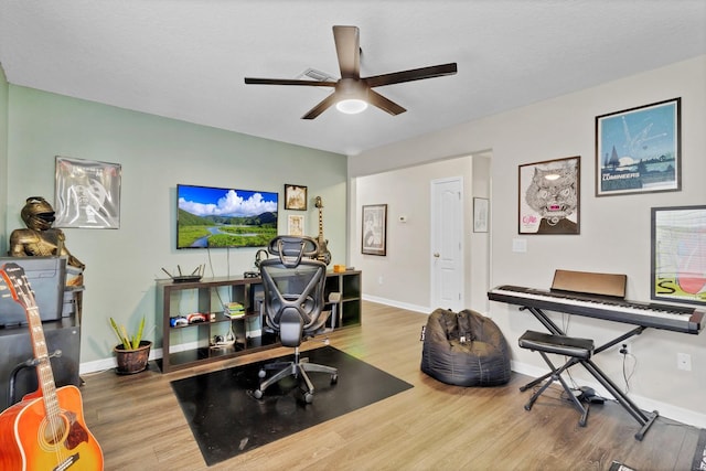 office space with ceiling fan, baseboards, and wood finished floors