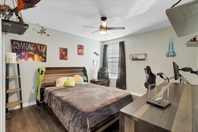 bedroom featuring ceiling fan, baseboards, and wood finished floors