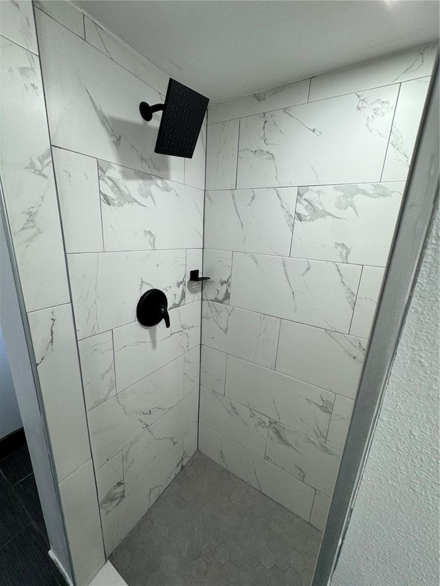 bathroom with a tile shower