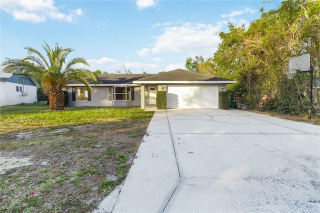 single story home with a garage, driveway, and stucco siding