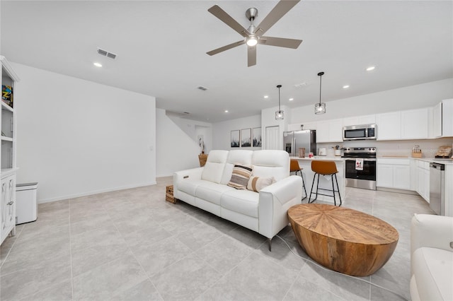 living room featuring baseboards, recessed lighting, visible vents, and ceiling fan