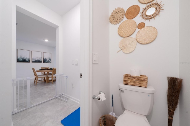 bathroom featuring tile patterned floors, visible vents, baseboards, and toilet