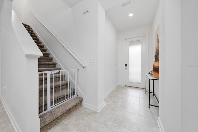 entryway with visible vents, recessed lighting, stairway, tile patterned flooring, and baseboards