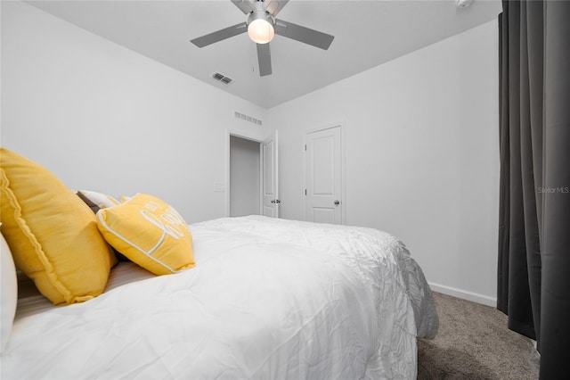 carpeted bedroom featuring visible vents, baseboards, and ceiling fan