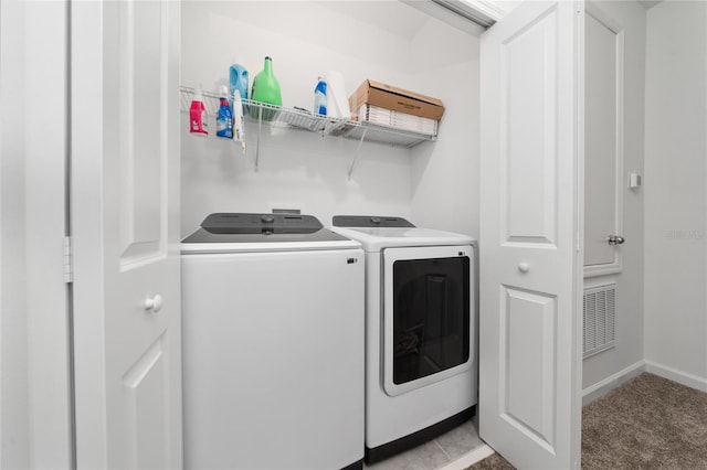 clothes washing area featuring visible vents, baseboards, light carpet, laundry area, and separate washer and dryer