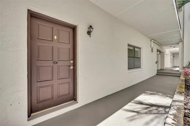 property entrance with stucco siding