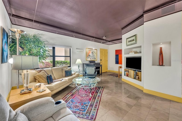 living room featuring baseboards and a wood stove