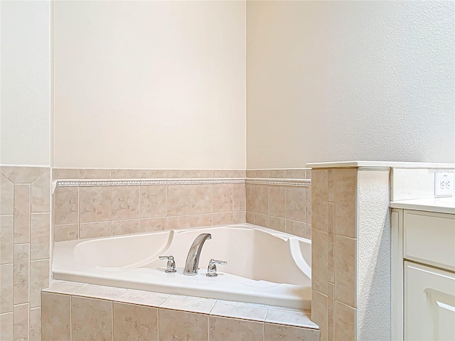 full bath with a garden tub and vanity