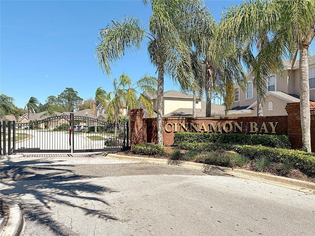 community / neighborhood sign featuring a residential view and a gate