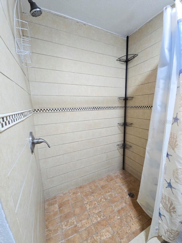 bathroom with tiled shower