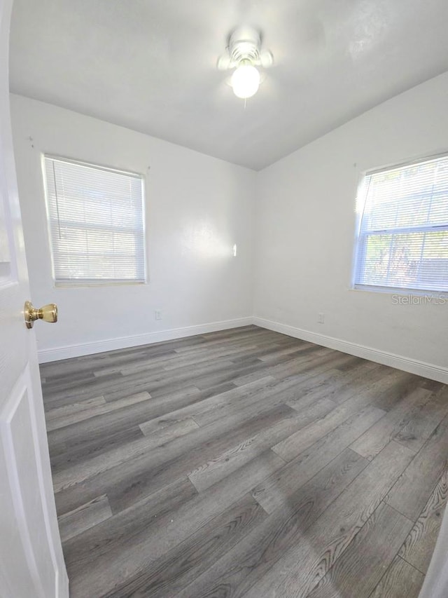 unfurnished room featuring baseboards, ceiling fan, and wood finished floors