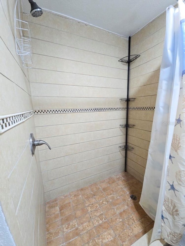 full bath featuring tiled shower