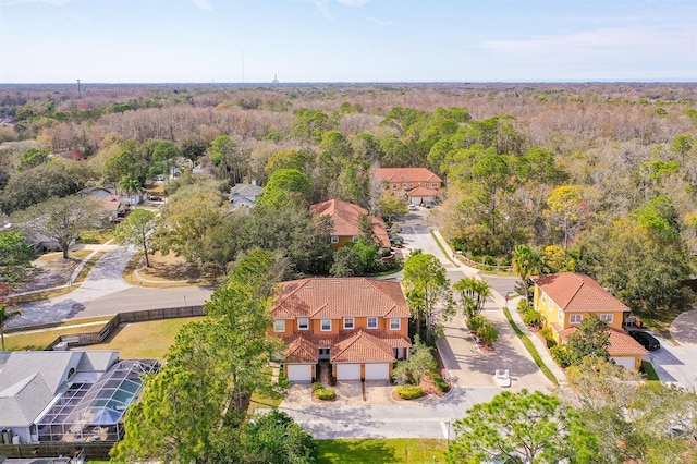 aerial view featuring a residential view and a wooded view