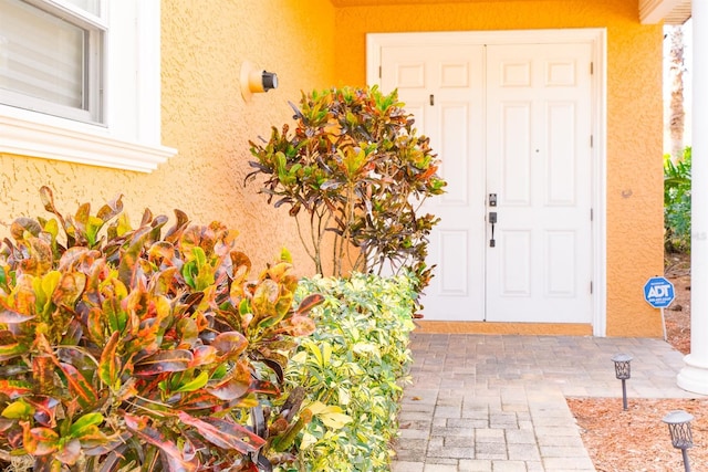 doorway to property with stucco siding