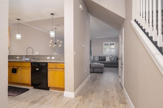 kitchen with a sink, light wood finished floors, ornamental molding, and dishwasher