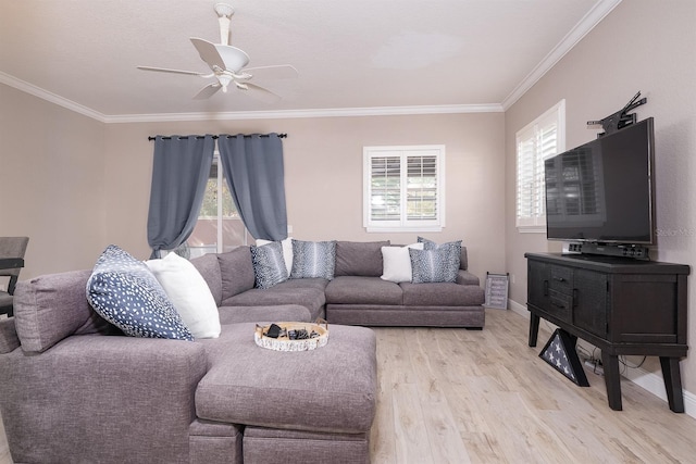 living room with light wood finished floors, baseboards, ornamental molding, and a ceiling fan