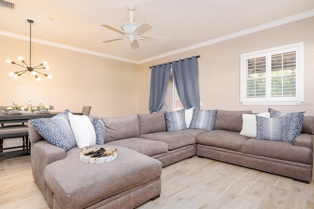 living room featuring light wood-type flooring, ceiling fan with notable chandelier, visible vents, and ornamental molding