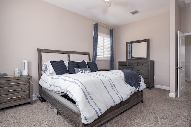 bedroom with baseboards, a ceiling fan, visible vents, and light colored carpet