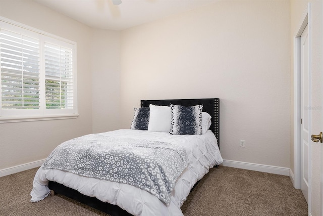 bedroom featuring a ceiling fan, carpet, and baseboards