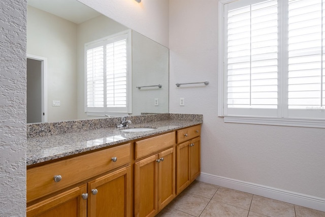 bathroom featuring baseboards, vanity, and tile patterned floors