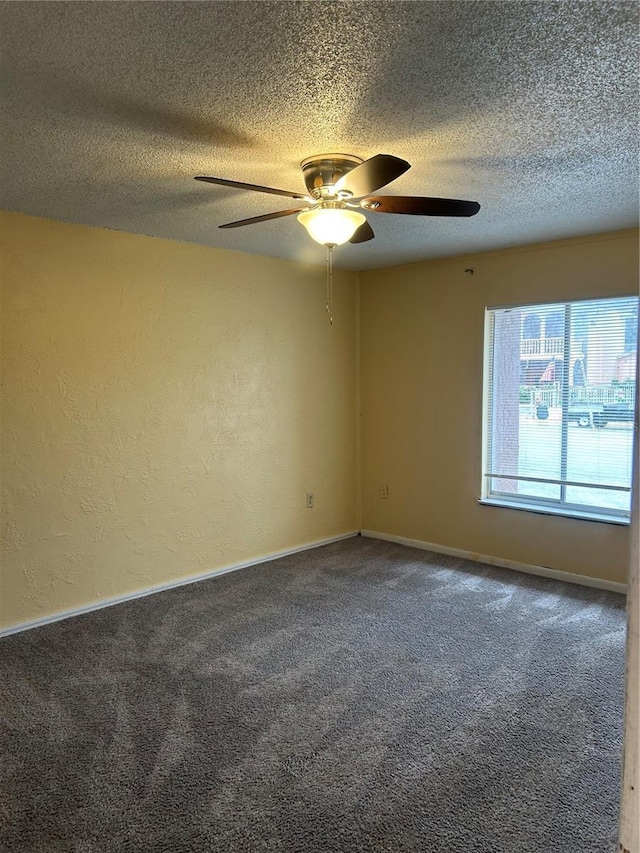 unfurnished room featuring carpet, baseboards, a textured ceiling, and a textured wall