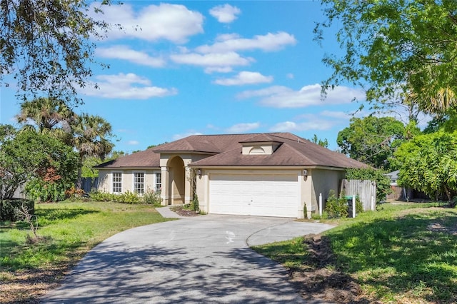 view of front of home featuring a front lawn, fence, concrete driveway, stucco siding, and a garage